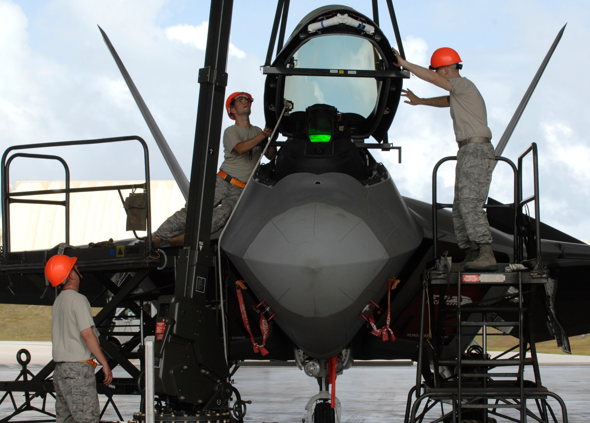 (L-R) Staff Sgt. Terry Vickery, Staff Sgt. Tim Sullivan, and Senior Airman Ryan Ott, 
install an F-22 Raptor canopy using an east-west hoist Feb. 18 at Andersen Air Force Base, Guam. The Raptors are deployed from Elmendorf Air Force Base, Alaska, to Guam , for three months as the Pacific's Theater Security Package. The stealth-fighters, along with associated maintenance and support personnel, comprise the 90th Fighter Squadron and will participate in various exercises that provide routine training in an environment different from their home station. All are F-22 Egress and Systems specialists, deployed from Elmendorf and assigned to the 36th Expeditionary Maintenance Squadron.


(U.S. Air Force photo/ Master Sgt. Kevin J. Gruenwald) released


