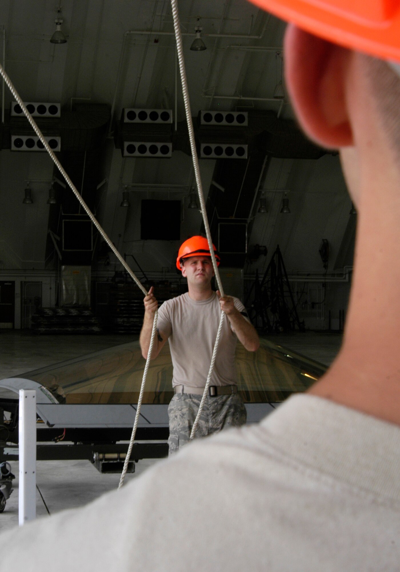 Senior Airman Ryan Ott and Staff Sgt. Tim Sullivan,  36th Expeditionary Maintenance Squadron F-22 Egress and Systems specialists, guide an F-22 canopy onto a Raptor at Andersen Air Force Base Feb. 18, 2008.  Members of the Expeditionary Fighter Squadron and the 36th Expeditionary Maintenance are deployed out of Elmendorf Air Force Base, Alaska, with more than 250 Airmen in support of the Pacifics Theater Security Package.(U.S. Air Force photo by Senior Airman Ryan Whitney)