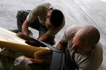 Senior Airman Ryan Ott and Staff Sgt. Tim Sullivan,  36th Expeditionary Maintenance Squadron F-22 Egress and Systems specialists, prepare an  F-22 canopy for installation at Andersen Air Force Base Feb. 18, 2008.  Members of the Expeditionary Fighter Squadron and the 36th Expeditionary Maintenance are deployed out of Elmendorf Air Force Base, Alaska, with more than 250 Airmen in support of the Pacifics Theater Security Package.(U.S. Air Force photo by Senior Airman Ryan Whitney)                                