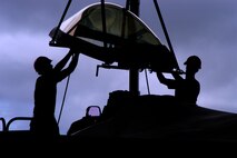 Senior Airman Ryan Ott and Staff Sgt. Tim Sullivan,  36th Expeditionary Maintenance Squadron F-22 Egress and Systems specialists, guide an F-22 canopy onto a Raptor at Andersen Air Force Base Feb. 18, 2008.  Members of the Expeditionary Fighter Squadron and the 36th Expeditionary Maintenance are deployed out of Elmendorf Air Force Base, Alaska, with more than 250 Airmen in support of the Pacifics Theater Security Package.(U.S. Air Force photo by Senior Airman Ryan Whitney)