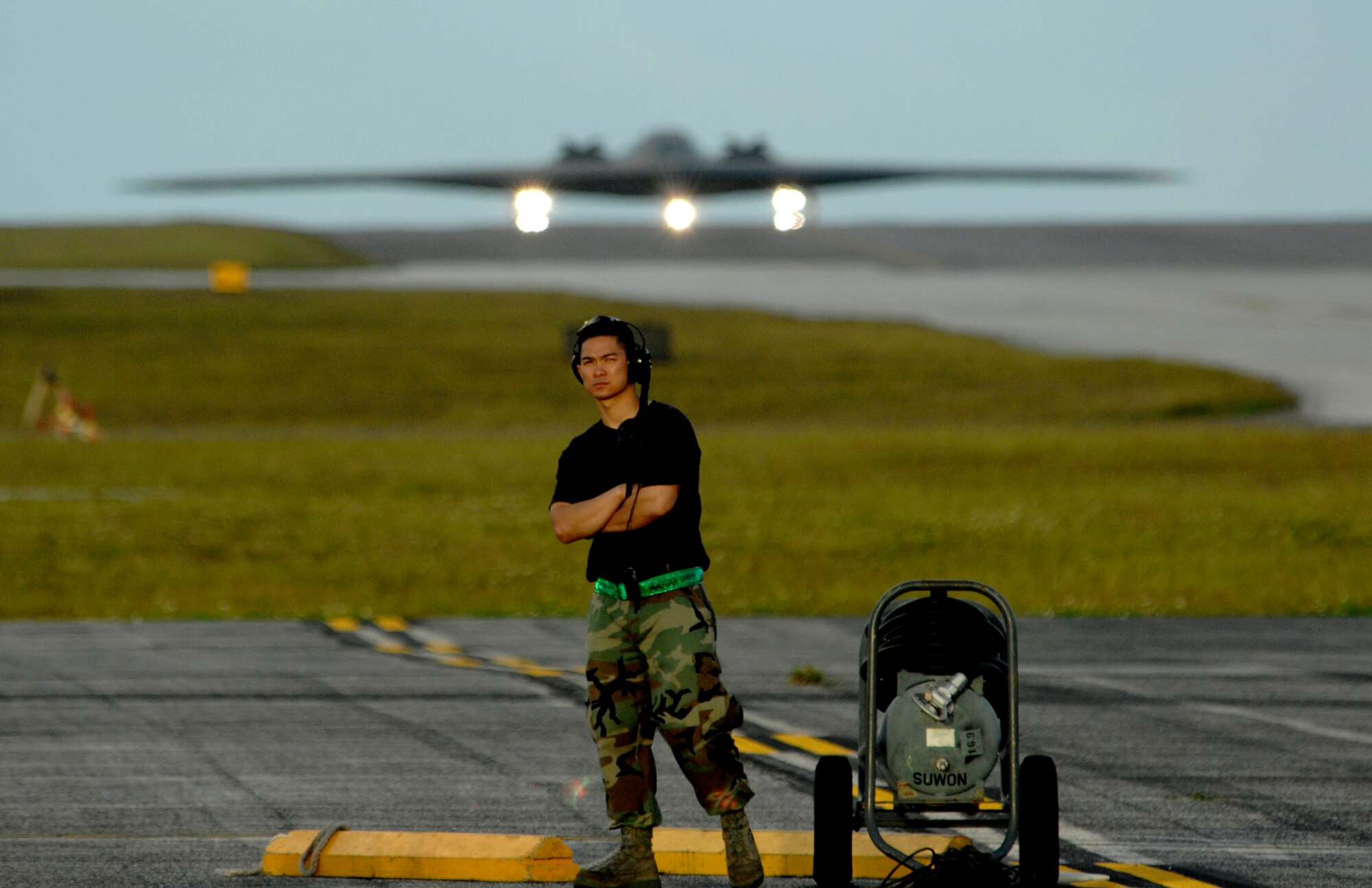 Airman 1st Class Sunny Ventura looks over the horizon for the second B-2 Spirit arrival  at Andersen Air Force Base, Guam Feb. 23.  More than 250 Airmen and four B-2 Spirits, 509th Bomb Wing, 13th Bomb Squadron Whiteman Air Force Base, Mo., began arriving here to replace the 23rd Expeditionary Bomb Squadron and its B-52 Stratofortress as the Pacific regions Continuous Bomber Presence. Airman Ventura is assigned to 36th Expeditionary Maintenance Squadron.

(U.S. Air Force photo/ Master Sgt. Kevin J. Gruenwald) released



