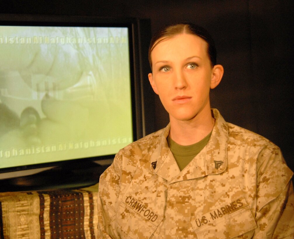 Marine Corps Cpl. Kimberly Crawford, a combat correspondent stationed at Camp Lejuene, N.C., prepares to read the news for the Pentagon Channel news report at Bagram Airfield, Afghanistan, Feb. 14, 2009. U.S. Army photo by Spc. Matthew Thompson