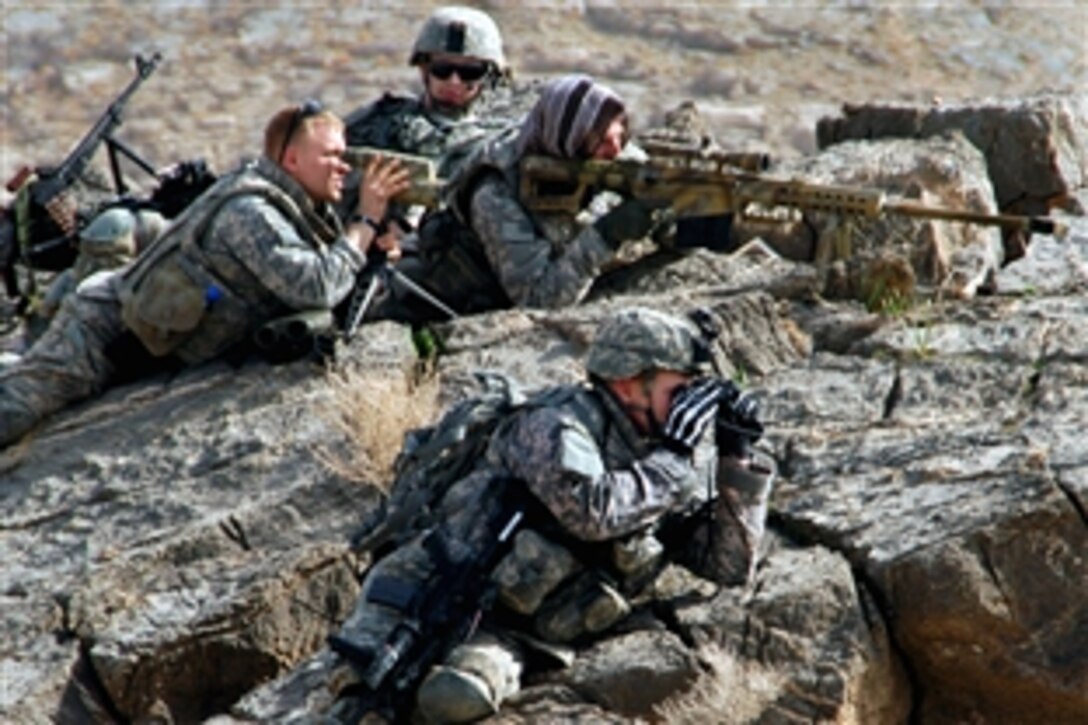 U.S. Army 1st Lt. Patrick Higgins surveys a village from a cliff while Spc. Aaron Trapley, Sgt. Gary Fordyce and Sgt. Nicholas Gauthier provide sniper overwatch and security during a foot patrol near Forward Operating Base Mizan, Afghanistan, Feb. 23, 2009. The soldiers are assigned to 1st Battalion, 4th Infantry Regiment.
