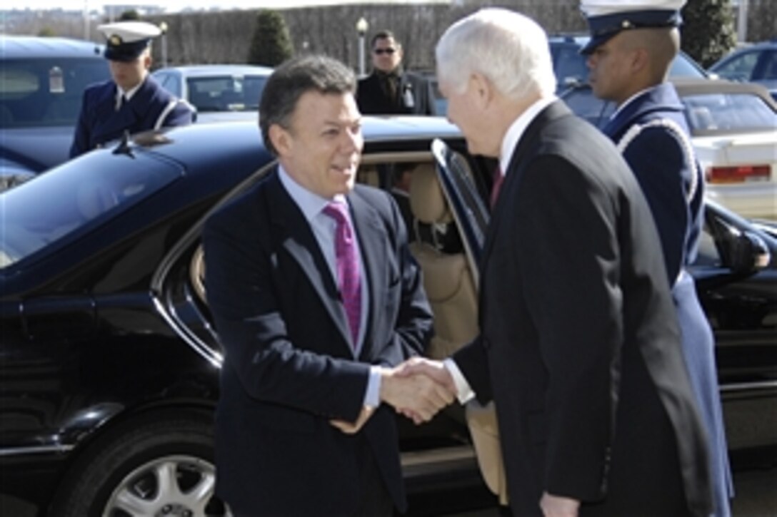 Defense Secretary Robert M. Gates, right, greets Colombian Minister of Defense Juan Manuel Santos upon his arrival at the Pentagon, Feb. 24, 2009. Gates will discuss bilateral defense issues with Santos. 
