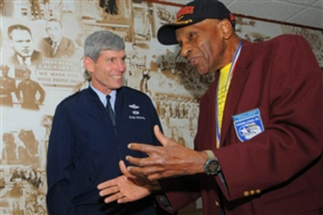 U.S. Air Force Chief of Staff Gen. Norton Schwartz visits with Dr. Granville Coggs, a former Tuskegee Airman, Feb. 19, 2009, in front of the Tuskegee Airmen mural in the main corridor of the 99th Flying Training Squadron on Randolph Air Force Base, Texas. 