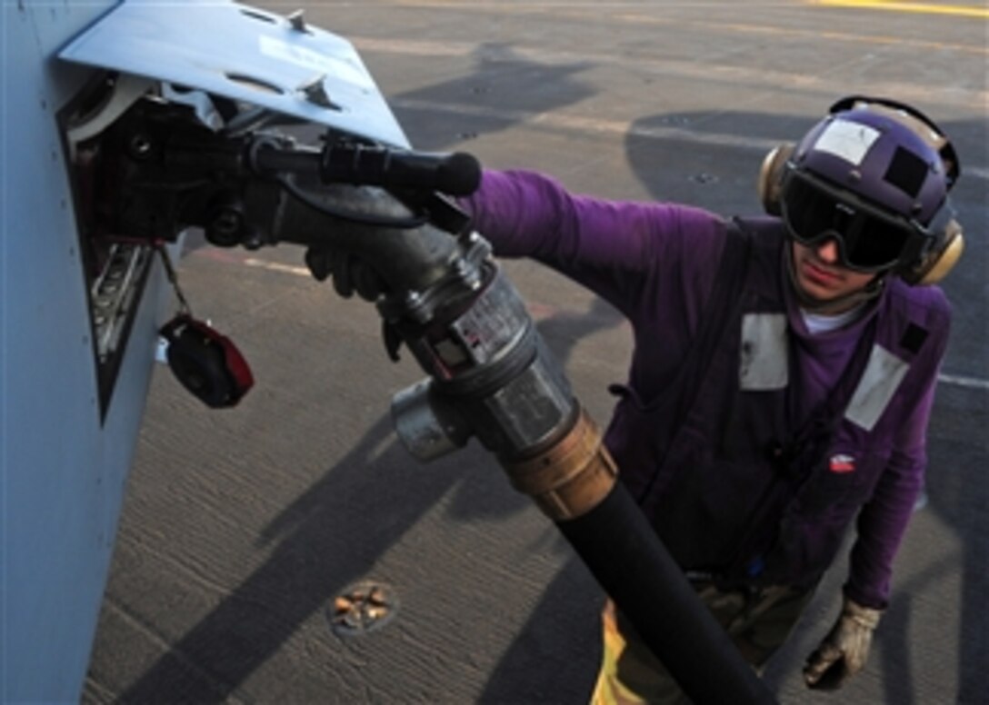 U.S. Navy Airman Joseph Cole fuels an F/A-18 Super Hornet aircraft aboard the USS Theodore Roosevelt (CVN 71) while the ship is underway in the Gulf of Oman on Feb. 21, 2009.  The ship and embarked Carrier Air Wing 8 are conducting operations in the U.S. 5th Fleet area of responsibility.  