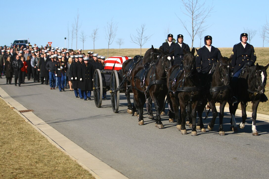 U.S. service members and friends and family of Marine Sgt. Trevor Johnson proceed to Johnson's final resting place at Arlington National Cemetery in Arlington, Va., Feb. 24. Lead horse "Lonesome" was donated to the U.S. Army Caisson Platoon by an archeologist from Johnson's home state, Montana.