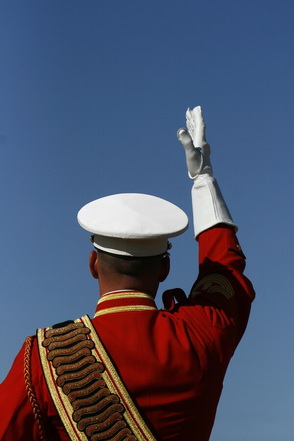 Wearing white leather gauntlets, Master Gunnery Sgt. Mark Miller, drum major for the U.S. Marine Corps' Drum and Bugle Corps, signal commands to musicians during a performance Feb. 24, 2009, at the Marine Corps Air Station in Yuma, Ariz. The performance marked the beginning of the band's annual tour. For approximately the last 20 years, the Drum and Bugle Corps' has trained annually in Yuma before beginning touring. Miller, the 20th drum major of "The Commandant's Own," is a native of Salisbury, Md.