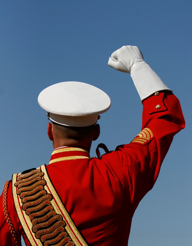 Wearing white leather gauntlets, Master Gunnery Sgt. Mark Miller, drum major for the U.S. Marine Corps' Drum and Bugle Corps, signal commands to musicians during a performance Feb. 24, 2009, at the Marine Corps Air Station in Yuma, Ariz. The performance marked the beginning of the band's annual tour. For approximately the last 20 years, the Drum and Bugle Corps' has trained annually in Yuma before beginning touring. Miller, the 20th drum major of "The Commandant's Own," is a native of Salisbury, Md.