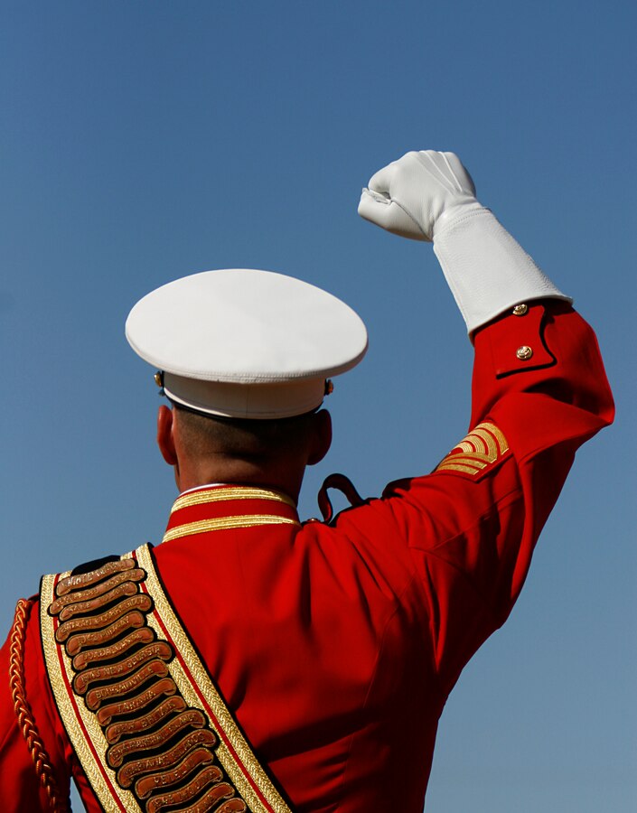 Wearing white leather gauntlets, Master Gunnery Sgt. Mark Miller, drum major for the U.S. Marine Corps' Drum and Bugle Corps, signal commands to musicians during a performance Feb. 24, 2009, at the Marine Corps Air Station in Yuma, Ariz. The performance marked the beginning of the band's annual tour. For approximately the last 20 years, the Drum and Bugle Corps' has trained annually in Yuma before beginning touring. Miller, the 20th drum major of "The Commandant's Own," is a native of Salisbury, Md.