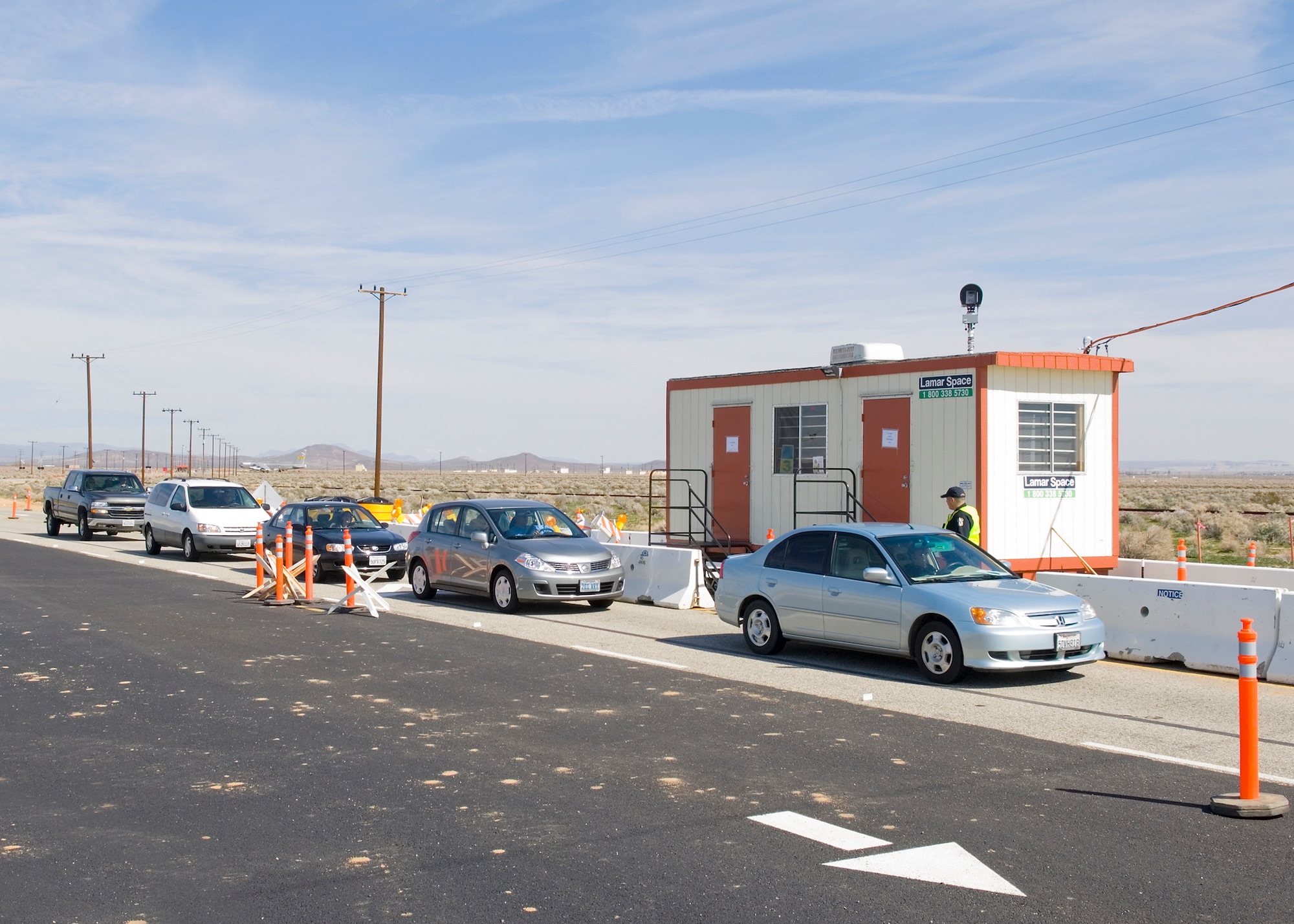 Cars line up to gain access to Edwards at the temporary Entry Control Facility Feb. 25.  The establishment of a temporary Entry Control Facility and changes to the traffic patterns at North Gate may lead to delays during peak hours because of ongoing construction. Drivers are advised to consider using alternate gates for access to the base.  North Gate construction will yield extended area lighting, new security barriers, and the installation of activation and warning systems.  The construction is scheduled to be completed in mid-July. (Air Force photo by Heather Anhalt)