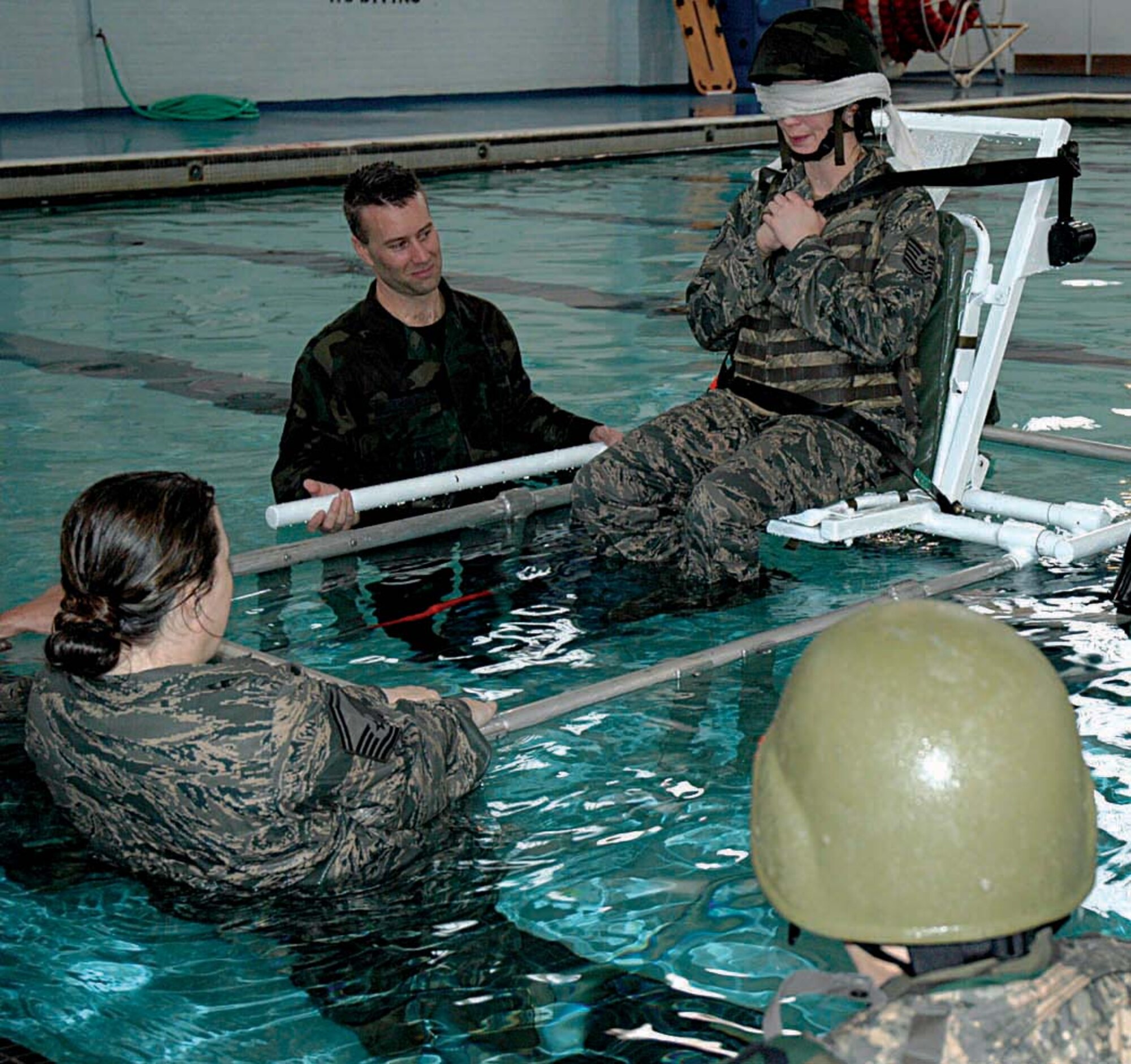 Blinfolded and buckled in, Tech. Sgt. Beth Riser, a Reservist with the 446th Security Forces Squadron, McChord Air Force Base, Wash., is moments away from getting acquainted with the water during Humvee rollover training Feb. 8 at nearby Fort Lewis. (U.S. Air Force photo/Airman First Class Patrick Cabellon)