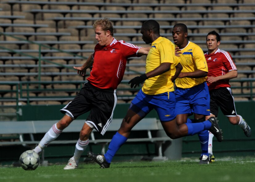 ABILENE, Texas - Barbados (yellow) competes in the fourth day of the CISM tournament against Canada at Shotwell Stadium here, Feb. 25. Barbados won 8-0. Also in action Brazil defeated Suriname 6-0. (U.S. Air Force photo by Airman 1st Class Stephen Reyes) 