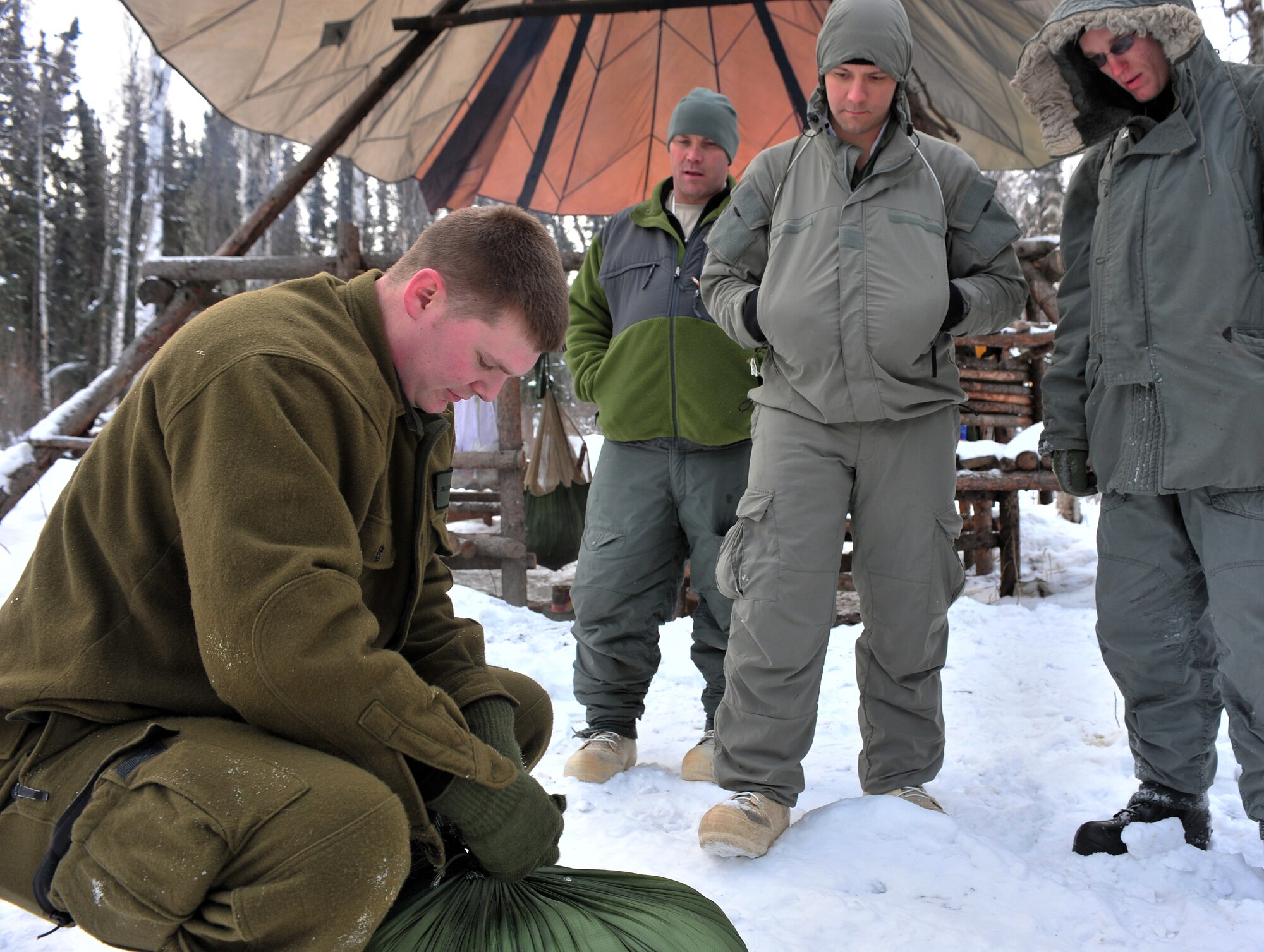 Senior Airmen Jess Evans, Detachment 1, 66th Training Squadron, Arctic Survival School Instructor, demonstrates making a door plug Feb. 25, 2009, Eielson Air Force Base, Alaska. A door plug is used to insulate the opening of a thermalized A-frame shelter. (U.S. Air Force photo/Airman 1st Class Willard E. Grande II)