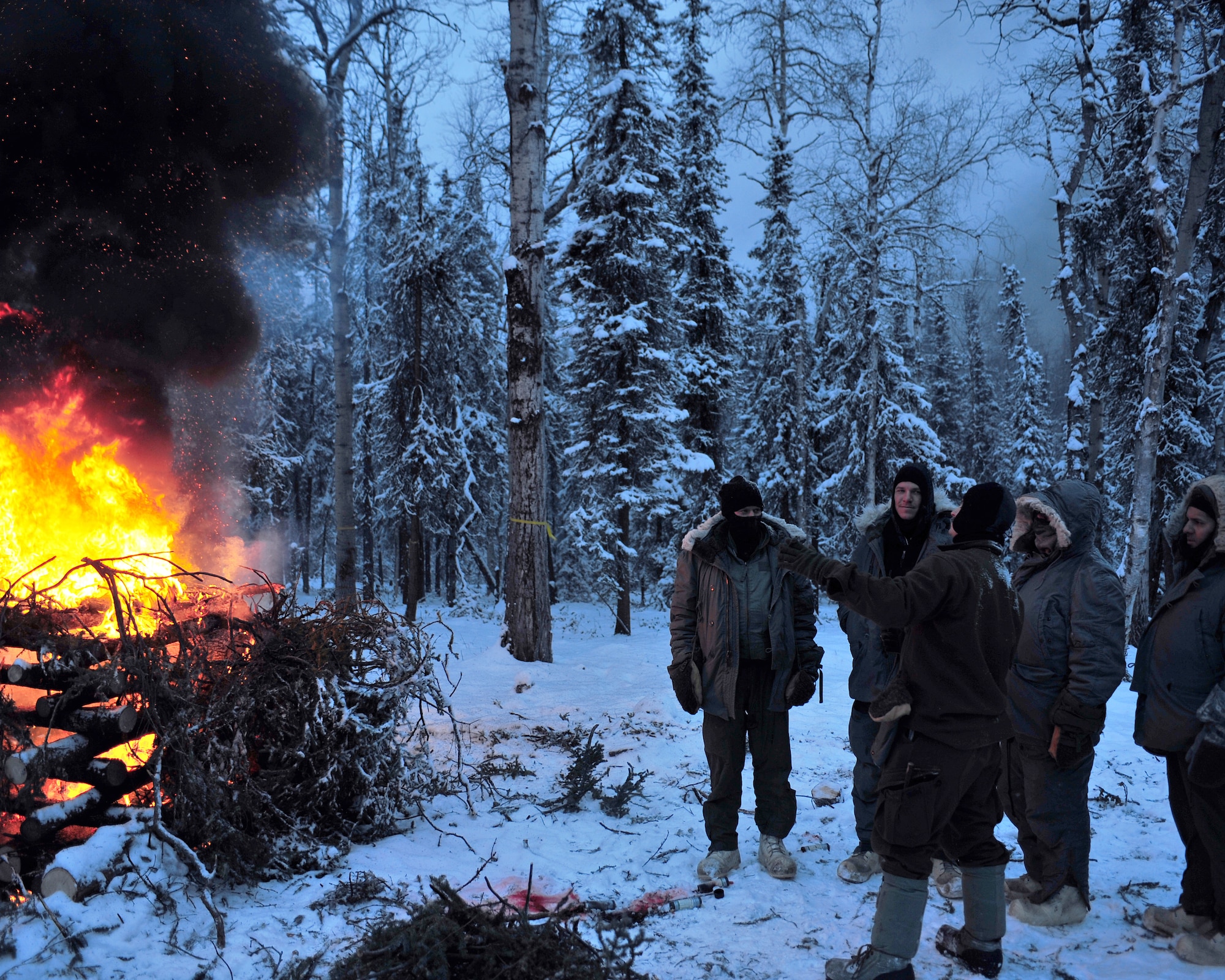 Senior Airman Chris Walsh, Detachment 1, 66th Training Squadron, Arctic Survival School Instructor, explains the uses of signal fires Jan. 30, 2009, Eielson Air Force Base, Alaska. Signal fires are one method of signal and recovery and one of the basic survival needs. (U.S. Air Force photo/Airman 1st Class Willard E. Grande II)