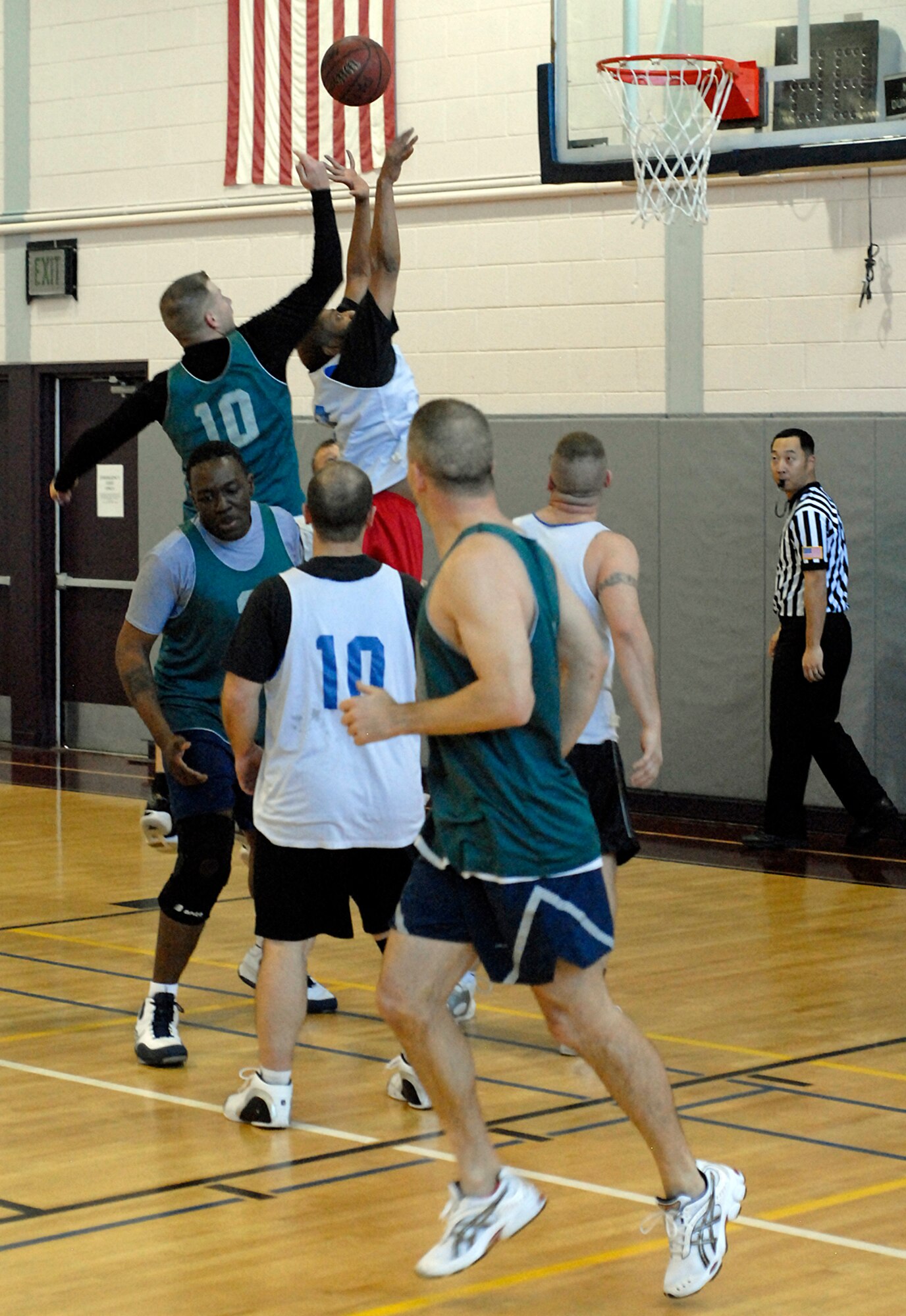 21st Operations Group player, Tom Clark, 10, tips the ball away from 21st Medical Group player, Prince Porter, during intramural action recently.  (U.S. Air Force photo by Larry Hulst)