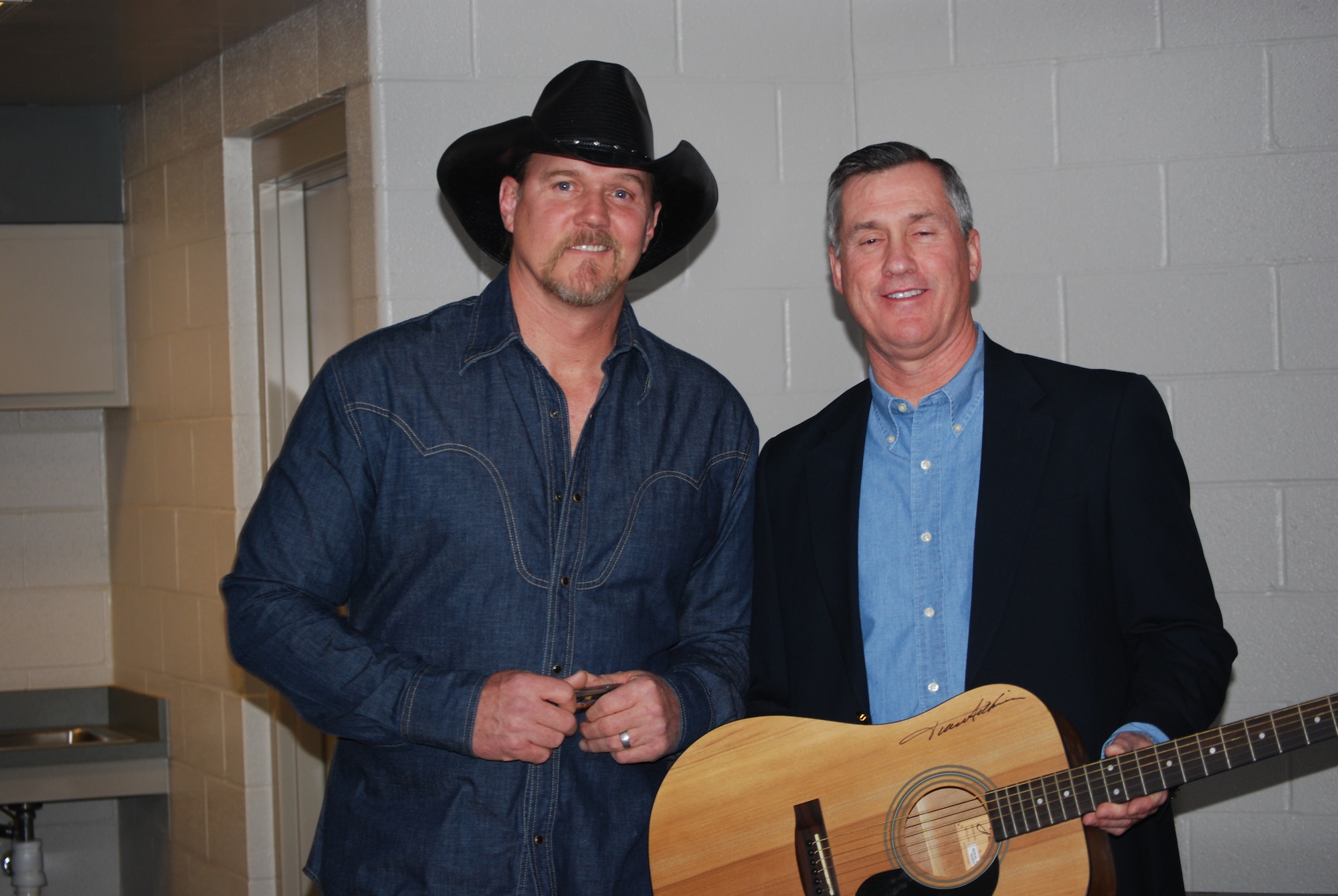 82nd Training Wing Commander Brig. Gen. O.G. Mannon accepts an autographed guitar from country music stars Trace Adkins and Craig Morgan, on behalf of Sheppard personnel. The gift was presented  just moments before Mr. Adkins appeared on stage at the Kay Yeagar Coliseum. The singers gave 1,000 tickets for Sheppard personnel to enjoy their concert Feb. 21. (U.S. Air Force Photo\Debi Smith)
