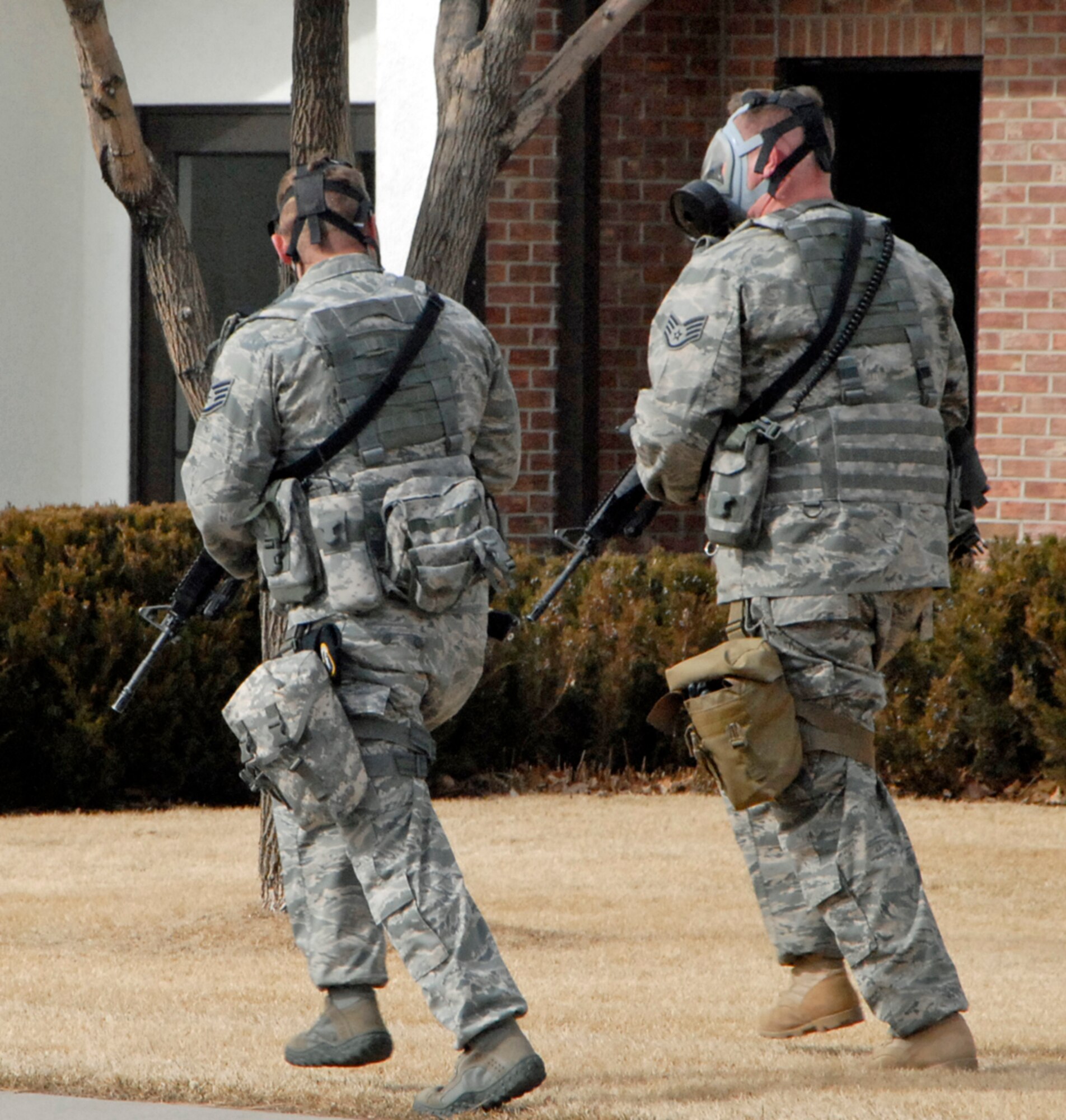 Staff Sgts. Lamar Thomas (left) and Nickolas Hinton, 21st Security Forces Squadron, respond to a hostage scenario during Condor Crest. The exercise, held Feb. 9 to 12, is designed to test how the wing responds to emergent situations in order to sharpen installation protection and hone warrior skills. (U.S. Air Force photo by Dennis Howk)