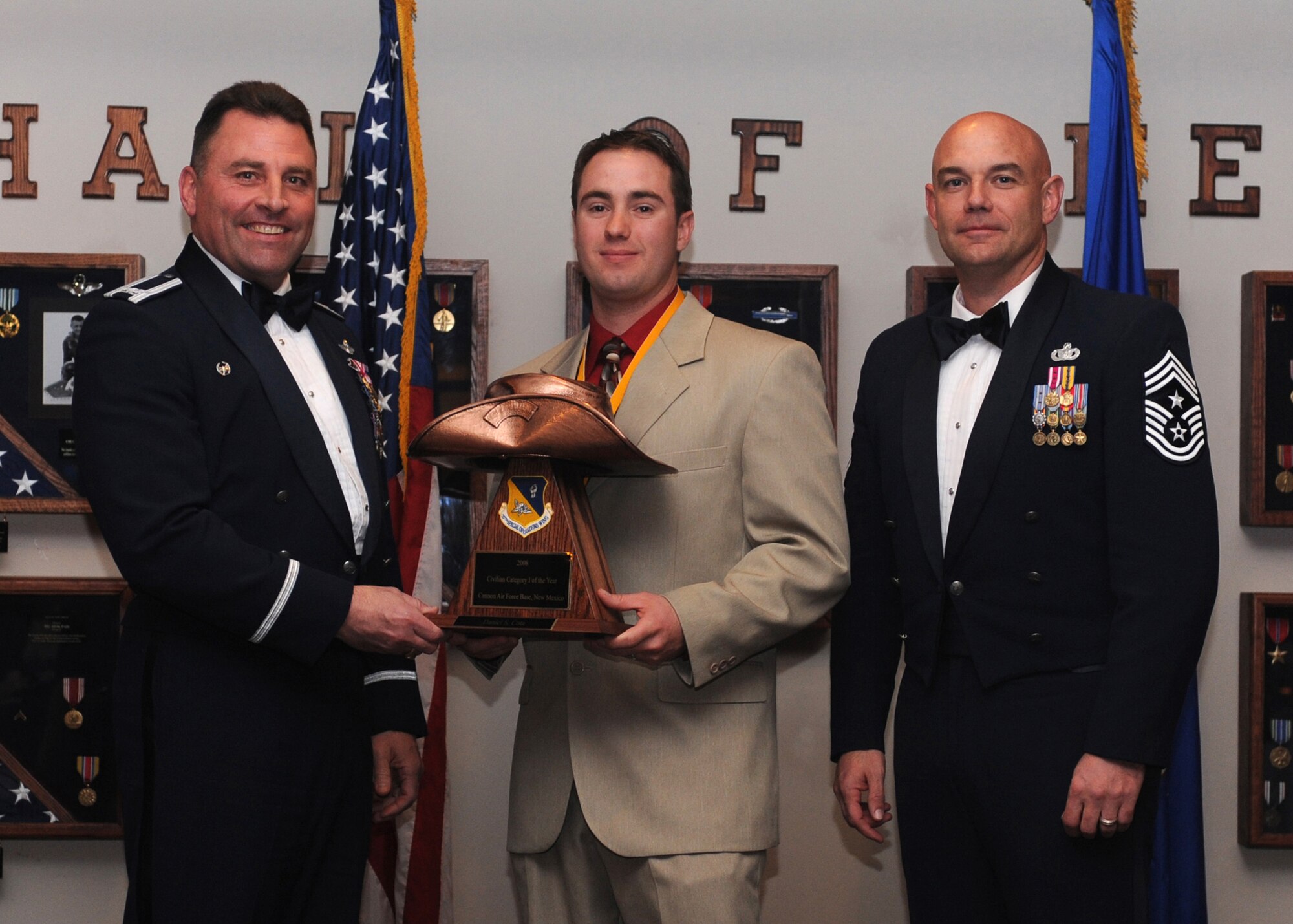 CANNON AIR FORCE BASE, N.M.  -- Daniel Cota, 27th Special Operations Mission Support Group, receives the Civilian of the Year, Category I award from (left) Col.Timothy Leahy, 27th Special Operations Wing commander, and (right) Chief Master Sgt. Daniel Fischer, wing command chief. The wing's top Airmen and civilians were recognized at the annual awards dinner at The Landing Feb. 21. (U.S. Air Force photo/Airman 1st Class Evelyn Chavez) 