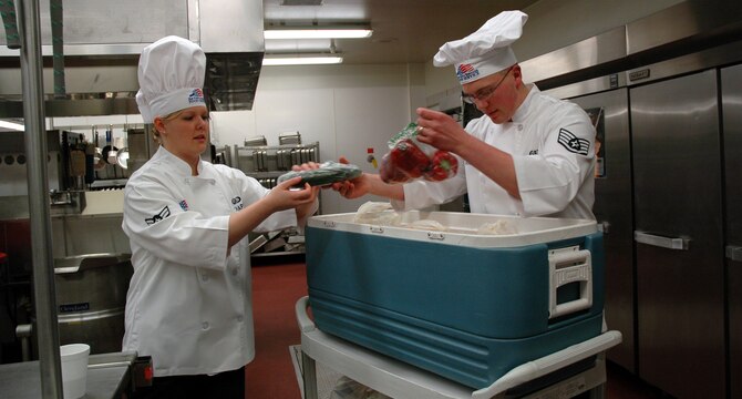 Airman 1st Class Elizabeth Chapin and Staff Sgt. Michael Fellows get their ingredients together prior to the start of the annual Warrior Chef competition Feb. 19 at the Elkhorn Dining Facility. (U.S. Air Force photo/Valerie Mullett)