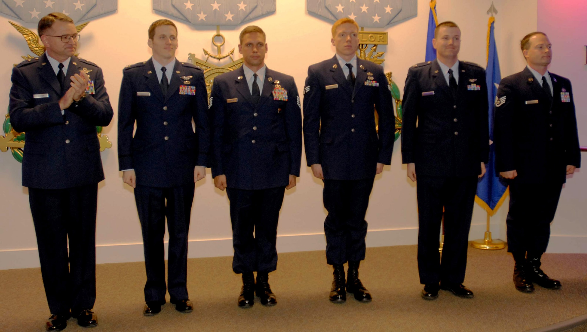 Maj. Gen. Marke Gibson applauds five special operations Airmen who received awards at the Hall of Heroes in the Pentagon Feb. 24. The honorees are (left to right): Capt. Christopher G. Wilson, Tech. Sgt. John C. DeMaso, Senior Airman Alexander W. Royal, Capt. Brett E. Plummer and Staff Sgt. Justin M. Cremer. They were each awarded a plaque and are authorized to wear the Air Force Recognition Ribbon. General Gibson is the Air Force director of operations. (U.S. Air Force photo/Staff Sgt. J.G. Buzanowski)