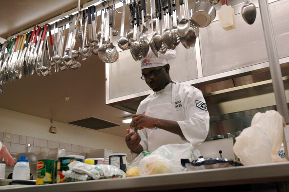 Staff Sgt. Jeremy Smith, 12th Missile Squadron, double checks the label on one of the spices he chose to use for his catfish dish in the annual Warrior Chef competition Feb. 19. He and his partner, Airman 1st Class Lynsey Mills got into the kitchen first and were the first to present their food to the judges. (U.S. Air Force photo/Valerie Mullett)