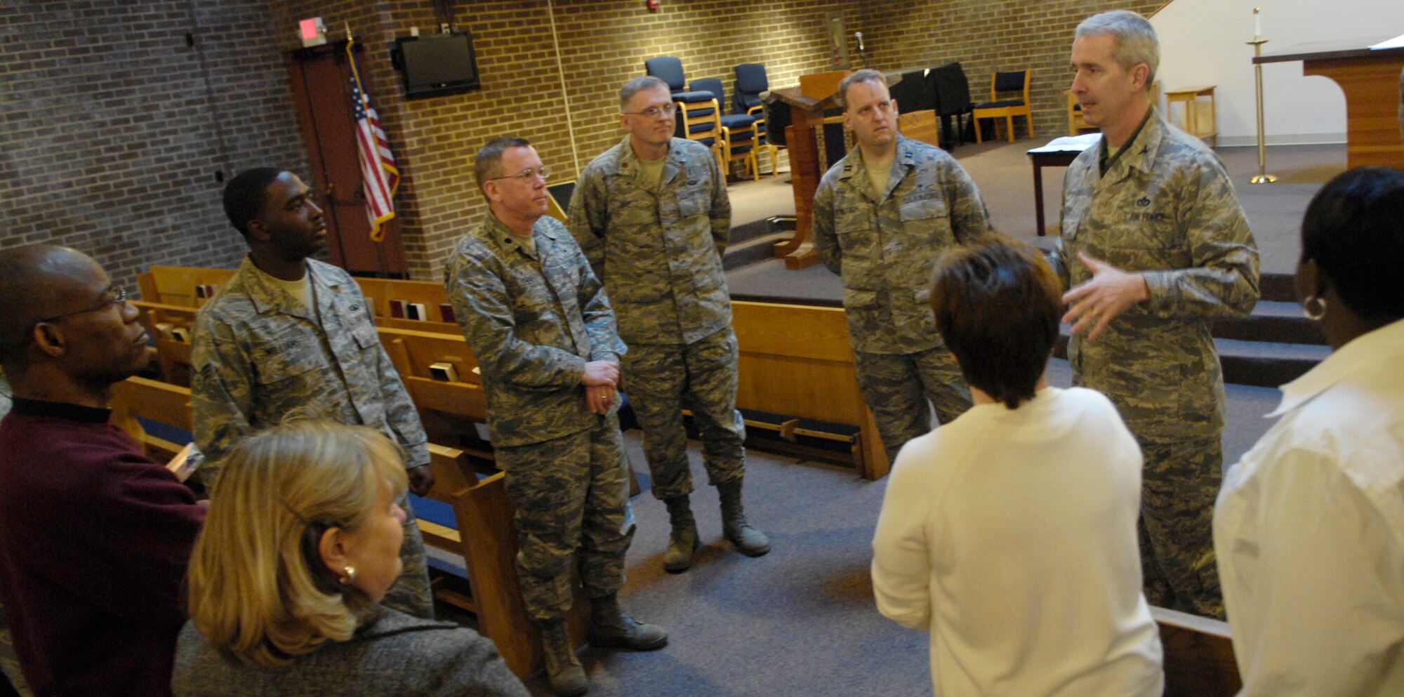 Col. Jon A. Roop, 11th Wing commander, speaks with Bolling’s chapel staff after an awards presentation by Maj. Gen. Ralph J. Jodice II, Air Force District of Washington commander, at Bolling’s main chapel Feb. 25. (U.S. Air Force photo by Senior Airman Alexandre Montes)
