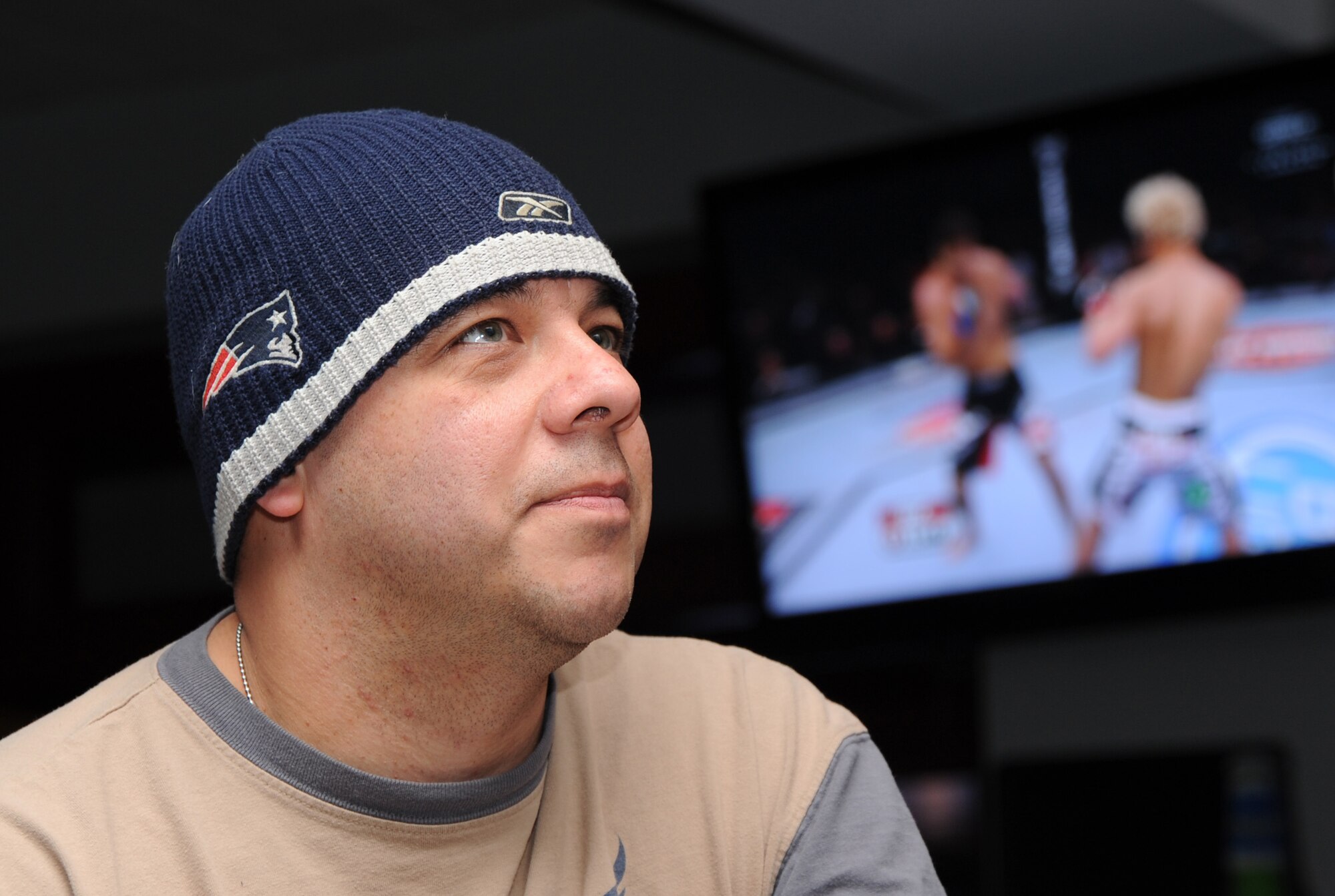 MCCONNELL AIR FORCE BASE, Kan. -- Master Sgt. Nathan Mesta, 22nd Aircraft Maintenance Squadron, watches the Ultimate Fighting Championship on one of the Storm Cellar’s seven televisions, Feb. 21. The Storm Cellar provides events like the UFC and First Friday to give Airmen options other than to off base entertainment. (Photo by Senior Airman Roy Lynch) 