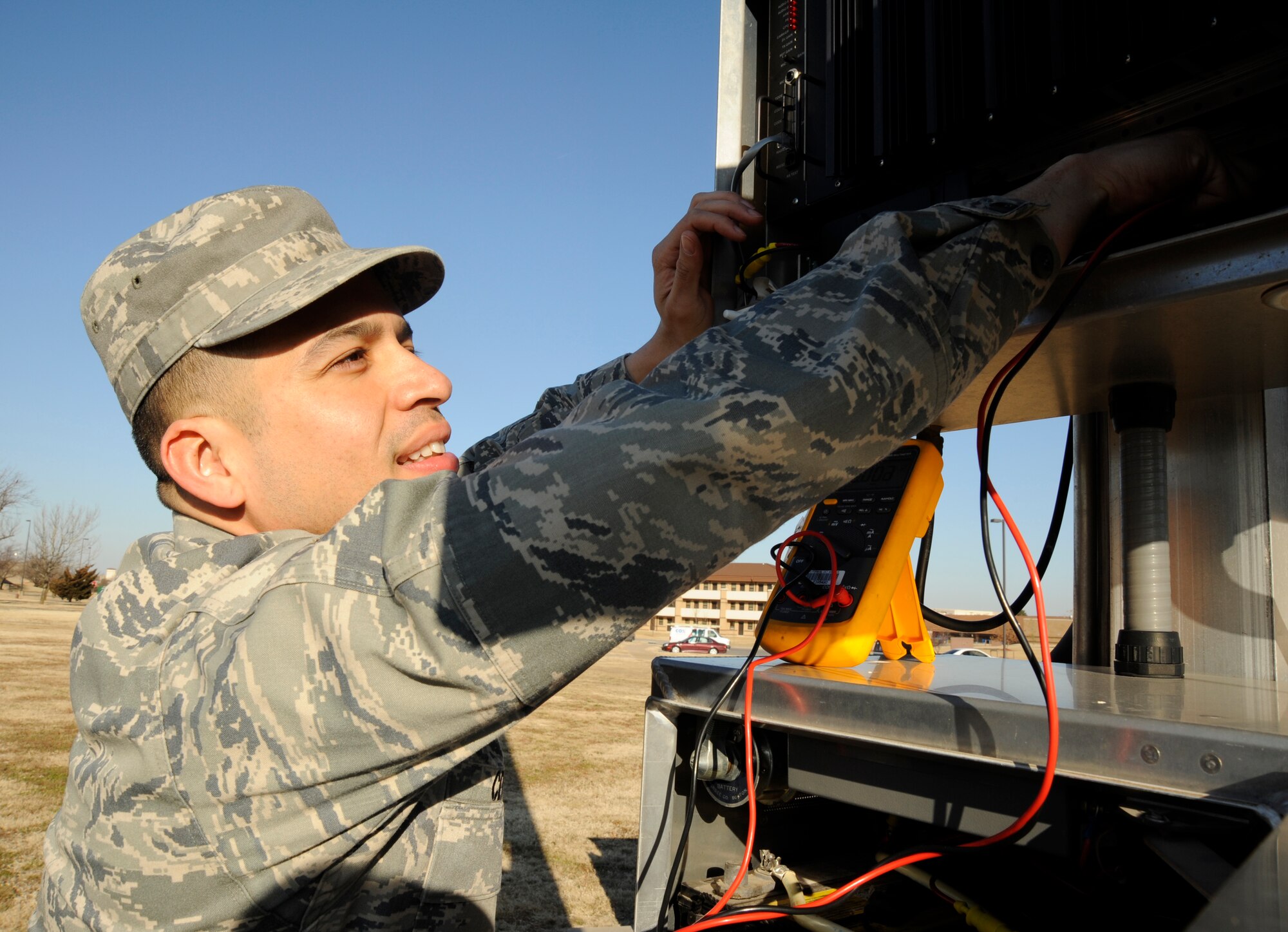 MCCONNELL AIR FORCE BASE, Kan. -- Airman 1st Class Alvaro Cermeno, 22nd Communications Squadron, checks batteries in tower four near the base dormitories for proper power voltage, Feb. 19. The towers provide base wide announcements and are also used daily to sound “Reveille,” the national anthem and “Taps.”(Photo by Senior Airman Laura Suttles)