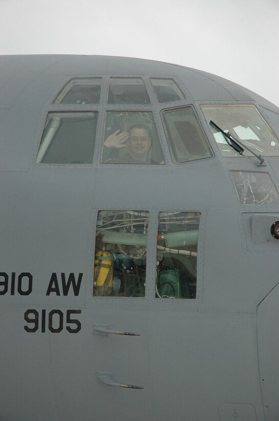 TAMPA, Florida - Reservist and Pilot, Captain Travis Adams waves from the cockpit of  a C-130H during a re-fueling stop at McDill Air Force Base.  The Youngstown Air Reserve Station took part in an Aerial Spray Certification Course in Ft. Myers, Florida.  