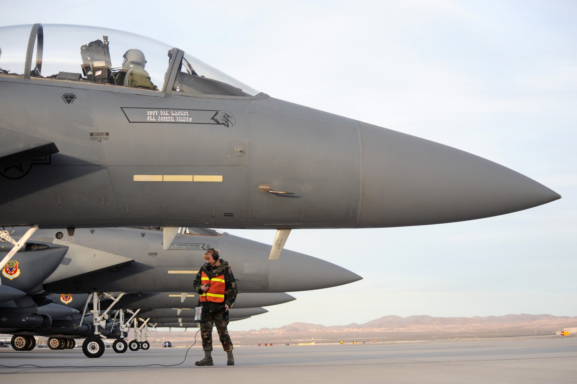 Staff Sgt.Tessa Burkett, a crew chief with the 366th Fighter Wing at Mountain Home Air Force Base, Idaho, talks to the pilot of a Mountain Home F-15E Strike Eagle that has landed at Nellis AFB, Nev., Feb. 20 for Red Flag 09-3.  Red Flag is a multinational exercise providing a realistic environment to practice combat scenarios.  (U.S. Air Force photo/Airman First Class Brett C. Clashman)