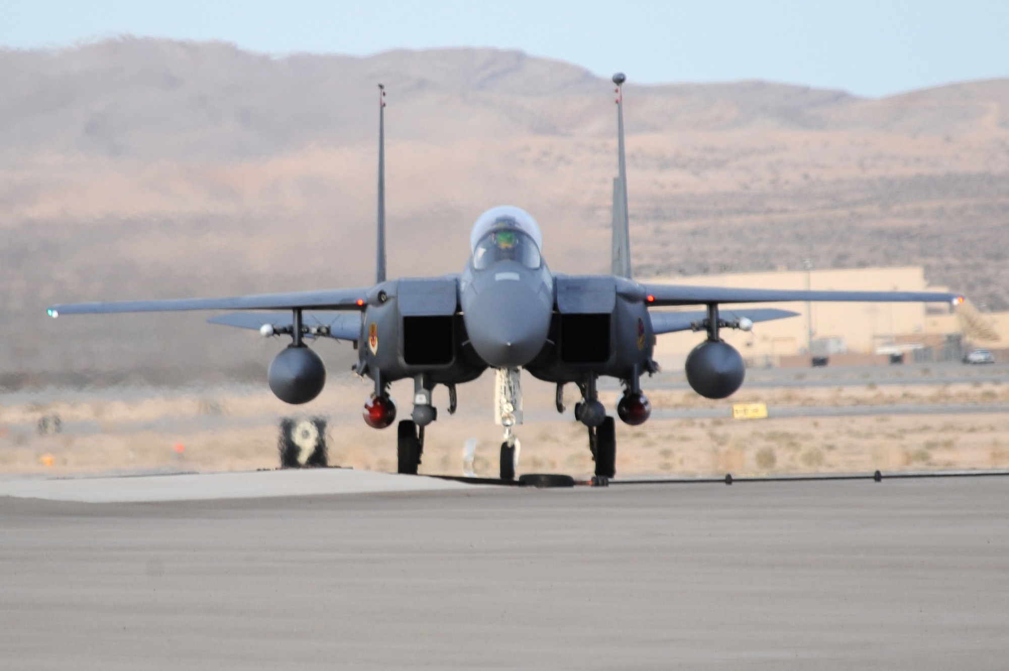 An F-15E Strike Eagle from the 366th Fighter Wing at Mountain Home Air Force Base, Idaho, taxis in after arriving at Nellis AFB, Nev., Feb 20 for Red Flag 09-3.  Red Flag is a multinational exercise providing a realistic environment to practice combat scenarios.  (U.S. Air Force photo/Airman First Class Brett C. Clashman)