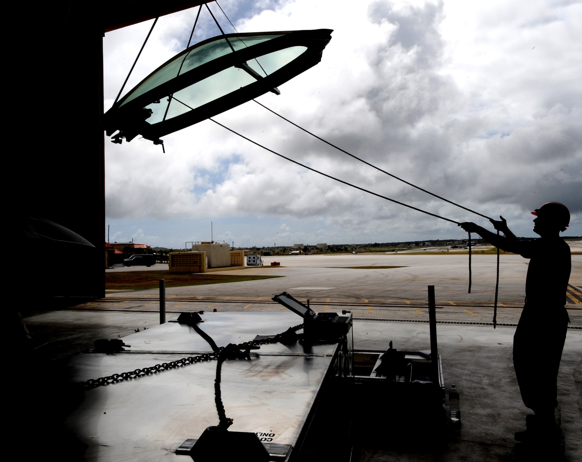 Senior Airman Ryan Ott positions an F-22 Raptor canopy using an east-west hoist Feb. 18 at Andersen Air Force Base, Guam. The Raptors are deployed from Elmendorf AFB, Alaska, to Guam for three months as the Pacific's theater security package. The base has received 12 of the $140 million dollar aircraft, and more than 250 Airmen as the theater security package. As part of the continuing force posture adjustments to address worldwide requirements, the United States continues to deploy additional forces like the F-22 throughout the Western Pacific. This is the latest example of the flexibility U.S. forces have to meet their ongoing commitments and security obligations throughout the Pacific region. Airman Ott is an egress technician deployed from Elmendorf AFB and assigned to 36th Expeditionary Maintenance Squadron. (U.S. Air Force photo/ Master Sgt. Kevin J. Gruenwald)