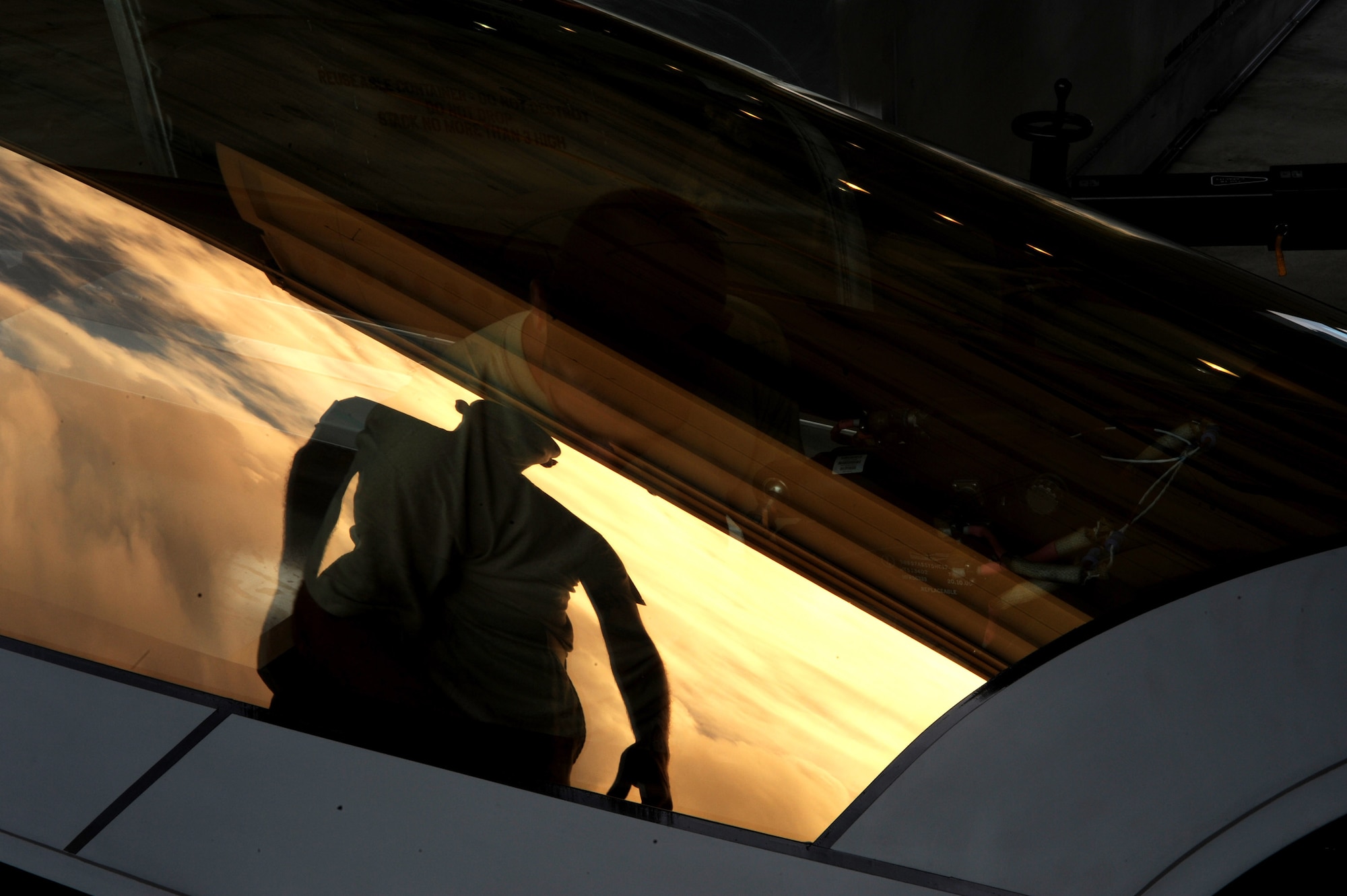 Senior Airman Ryan Ott looks over an F-22 Raptor canopy before installation Feb. 18 at Andersen Air Force Base, Guam. The Raptors are on a deployment from Elmendorf AFB, Alaska, to Andersen. The base has received 12 of the $140 million dollar aircraft, and more than 250 Airmen as the Pacific's theater security package. As part of the continuing force posture adjustments to address worldwide requirements, the United States continues to deploy additional forces like the F-22 throughout the Western Pacific. This is the latest example of the flexibility U.S. forces have to meet their ongoing commitments and security obligations throughout the Pacific region. Airman Ott is an egress technician deployed from Elmendorf AFB and assigned to 36th Expeditionary Maintenance Squadron. (U.S. Air Force photo/Master Sgt. Kevin J. Gruenwald)