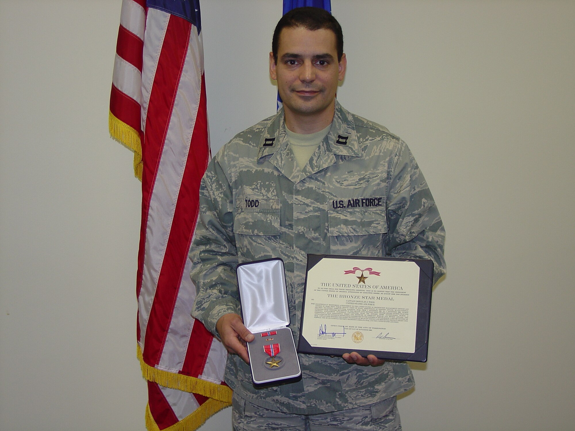 ALTUS AIR FORCE BASE, Okla. -- Capt. Douglas Todd, 97th Mission Support Group executive officer, holds the Bronze Star he received for his actions as a coalition logistics advisor in Iraq. The Bronze Star recognizes heroic or meritorious achievement or service, not involving participation in aerial flight, in connection with military operations against an armed enemy. (U.S. Air Force photo/Kevin T. Chandler)