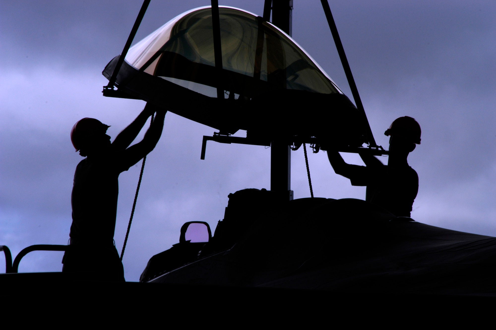 Senior Airman Ryan Ott and Staff Sgt. Tim Sullivan guide a canopy onto an F-22 Raptor at Andersen Air Force Base Feb. 18. Members of the 90th Expeditionary Fighter Squadron and the 36th Expeditionary Maintenance are deployed out of Elmendorf AFB, Alaska, with more than 250 Airmen in support of the Pacific theater security package. Sergeant Sullivan and Airman Ott are 36th Expeditionary Maintenance Squadron F-22 egress and systems specialists. (U.S. Air Force photo/Senior Airman Ryan Whitney)