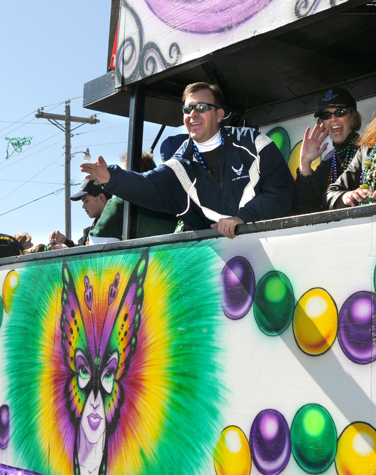 Brig. Gen. Greg Touhill, 81st Training Wing commander, and his wife, Charlene, ride on a float in Sunday’s North Bay Carnival Association’s Mardi Gras parade in D’Iberville.  The honor guard and the 336th Training Squadron’s state flag team also participated.  (U.S. Air Force photo by Kemberly Groue)