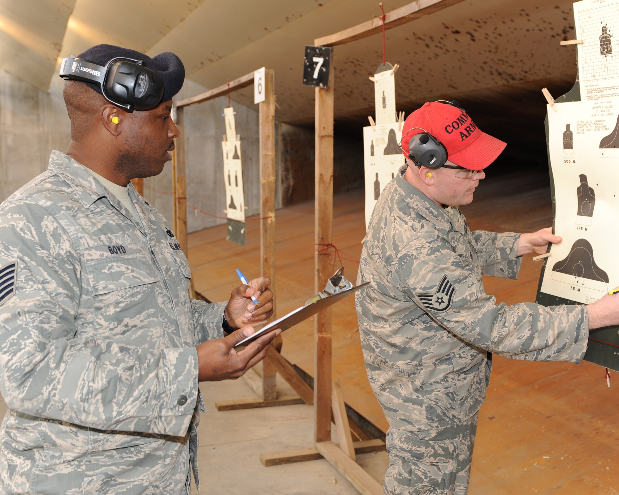 WHITEMAN AIR FORCE BASE, Mo. – Tech. Sgt. Stephen Boyd (left), 8th Air Force Security Forces, and Staff Sgt. Matthew Roof, 509th Security Forces Squadron, score targets during the shooting competition portion of Giant Sword II. Giant Sword II is a resurrection of Giant Sword, a Strategic Air Command Weapons Loading Competition held between 1958 - 1992. (U.S. Air Force photo/Airman 1st Class Carlin Leslie)