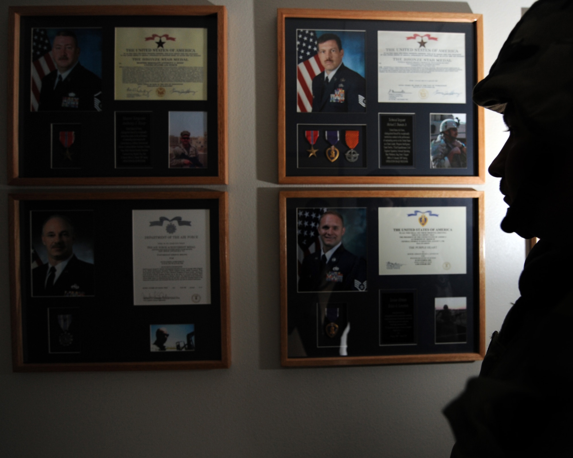WHITEMAN AIR FORCE BASE, Mo. - An Airman in full "battle rattle" observes the Heritage Wall in Whiteman's Professional Development Center. The wall, to be headed "A Legacy of Valor: Airmen in the Fight," honors airmen through chief master sergeants recognized for outstanding achievement, exceptionally meritorious service, actions of valor and wounds received in action. (U.S. Air Force photo/Staff Sgt. Charles Larkin)