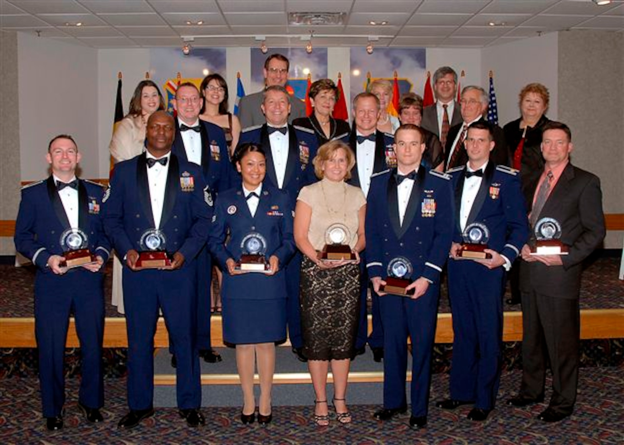 Col. David Petersen, 80th Flying Training Wing commander, and Chief Master Sgt. Norman Thierolf, the wing's command chief, pose with the 80th FTW annual award winners as they show off the awards that their hard work has earned them. (U.S. Air Force photo) 