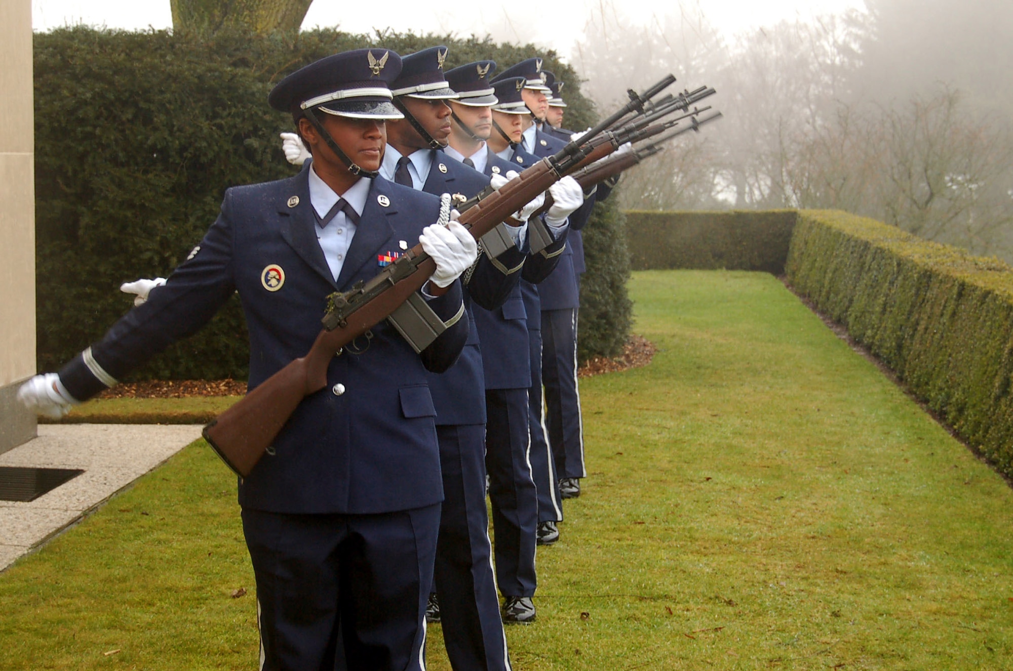 Honor guard members from Spangdahlem Air Base, Germany, give a 21-gun salute during a rosette-placing ceremony Feb. 20 at the Henri-Chapelle Cemetery and Memorial in Belgium. The event honored the nine Airmen of the McMurray Crew in World War II, who flew a B-24 bomber and were missing in action until remains were found in a field southwest of Berlin in 2002. (U.S. Air Force photo/2nd Lt. Kathleen Polesnak) 
