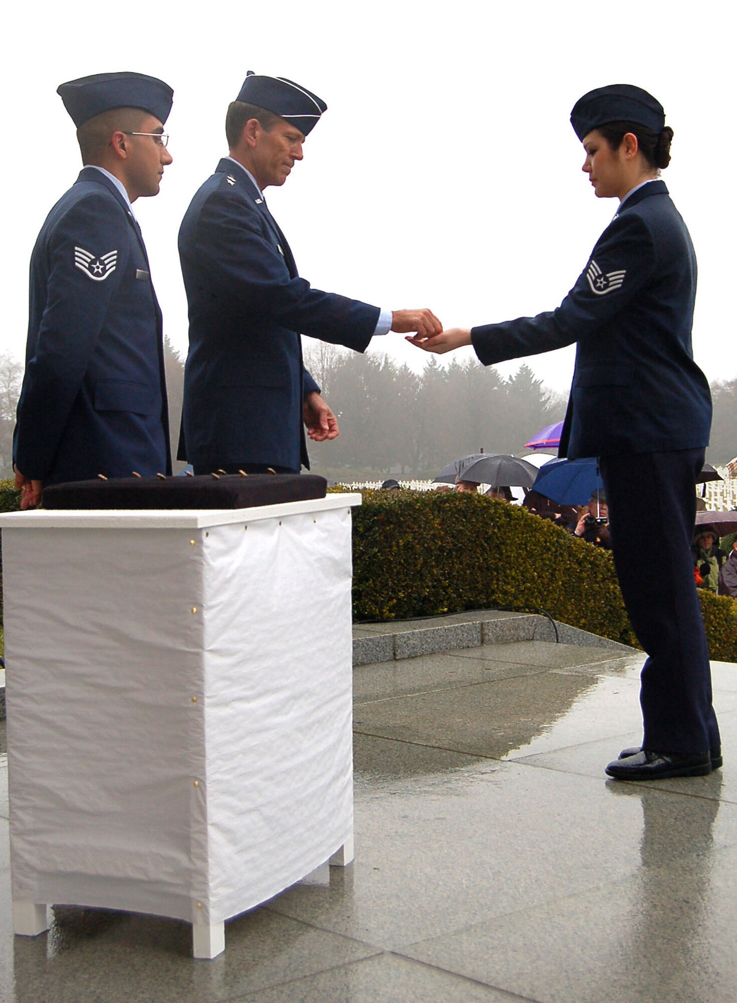 Staff Sgt. Melissa Johnson receives a rosette from Maj. Gen. Thomas B. Wright to place next to Staff Sgt. Walter O. Schlosser's name signifying he is no longer missing in action Feb. 20 at the Henri-Chapelle Cemetery and Memorial in Belgium. Sergeant Johnson works at the NATO Programming Centre's customer service desk, and General Wright is the operations deputy chief of staff of operations for Supreme Headquarters Allied Powers Europe. (U.S. Air Force photo/2nd Lt. Kathleen Polesnak) 
