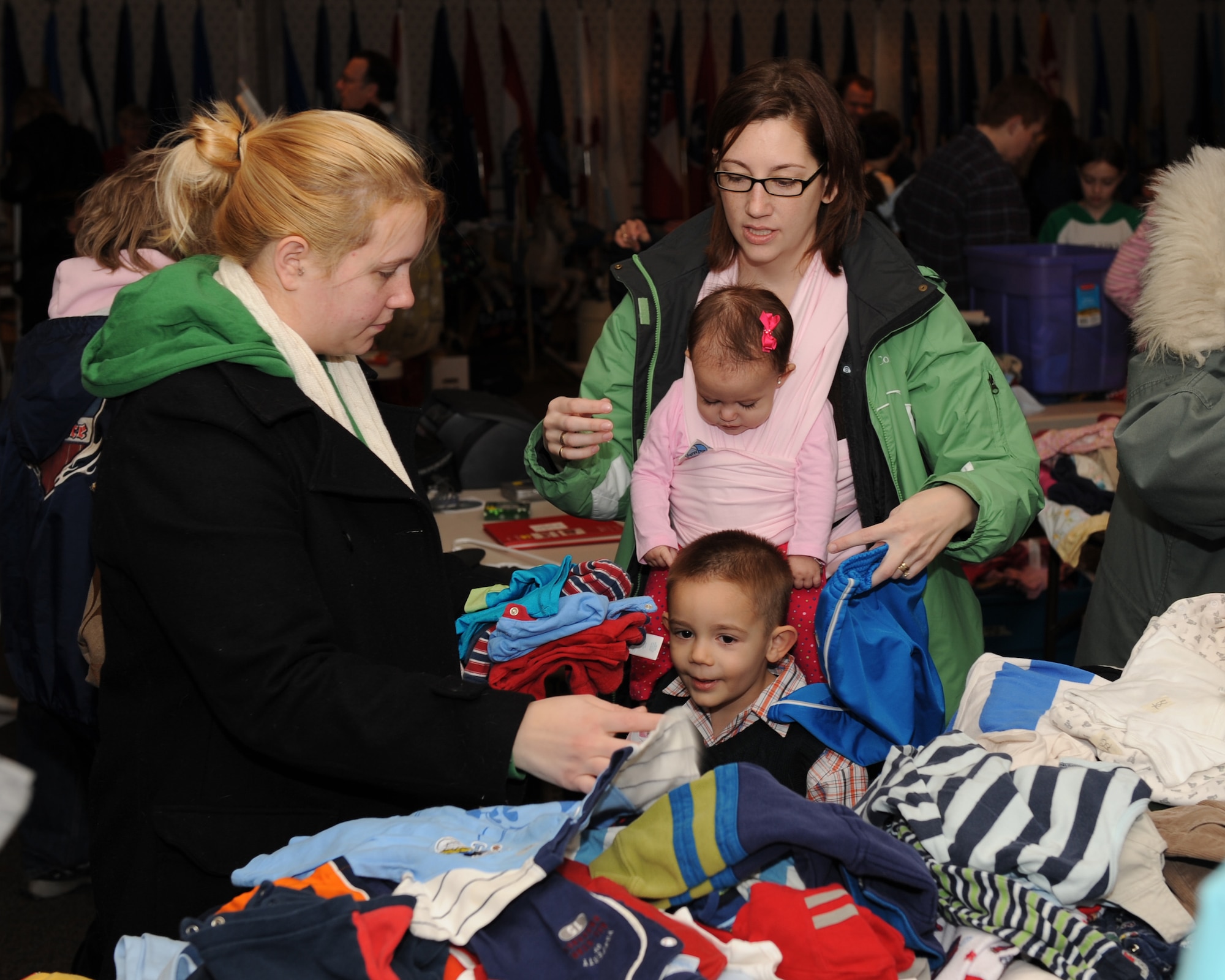 SCOTT AIR FORCE BASE, Ill. --Team Scott members pick through clothing during the Scott Base-Wide Yard Sale Saturday. Held at Rockwell Hall, the yard sale encourages Team Scott members to not only get rid of old items from their homes, but to also socialize with other families.(U.S. Air Force photo/Staff Sgt. Paul Villanueva) 