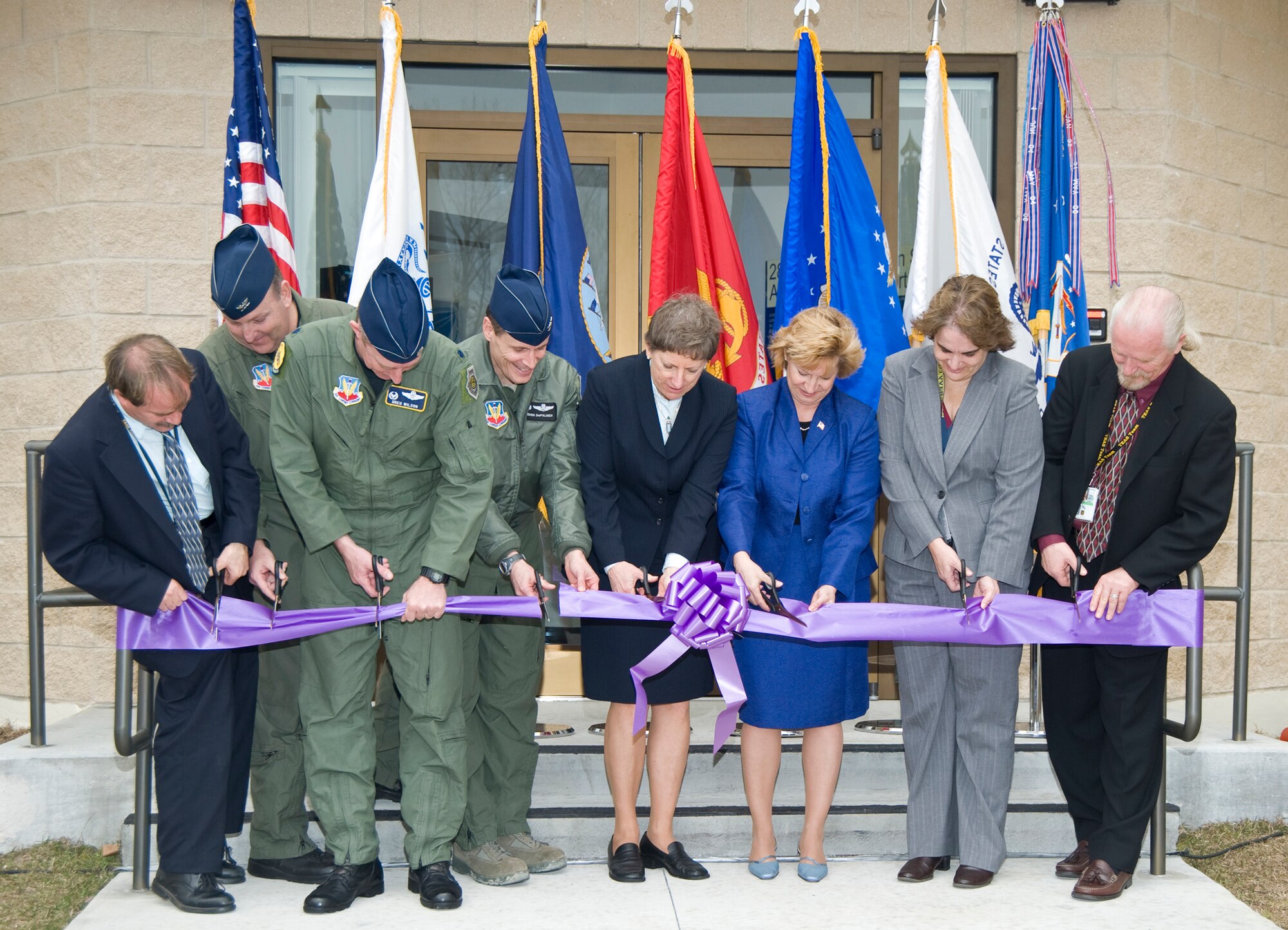 Members of the joint community as well as 53d Wing and 28th Test and Evaluation Squadron members joined in to cut the ribbon on the newly renovated and upgraded Dynamic Entry/Exit Test Module facility.  The facility tests chemical and biological effects on shelters and protective liners.
Left to right:  Vic Arca, 28 TES/D0U-Jacobs, Col. Chris Monahan, 53d Test Management Group commander, Lt. Col. Greg Wilson, 28 TES commander, Col Steve DePalmer, 53 WG commander, Donna Shandle, JPEO-CBD, Deputy JPM-NBC Contamination Avoidance,Terri Kocher, Keynote Speaker, Chem Bio Defense Program, T&E Executive, Sandra Wood, Deputy JPM-ColPro, Scott Matheson, 28 TES/D0U-Jacobs.  Courtesy photo.
