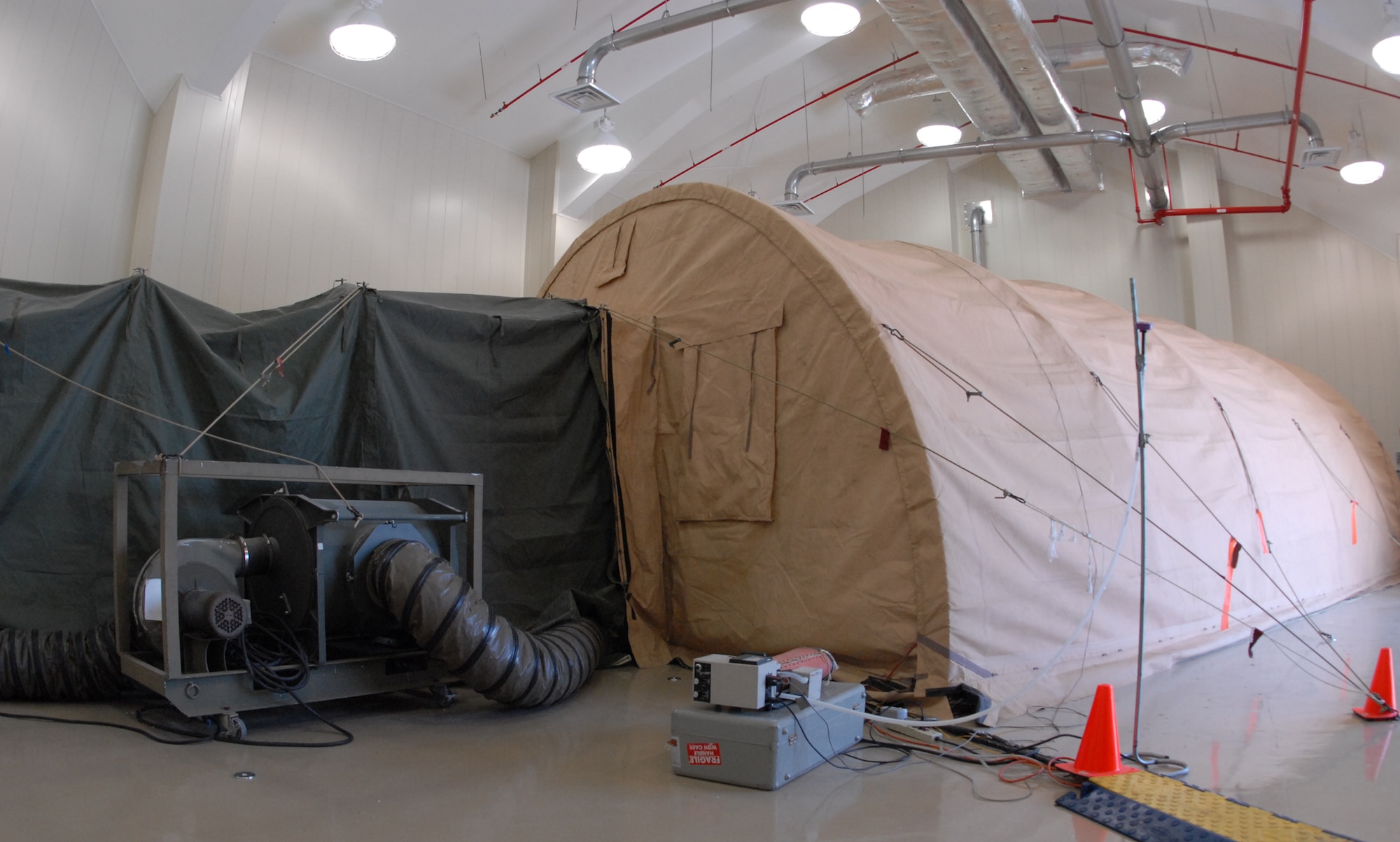 The tent is used to perform different chemical and biological tests and entry/exit procedures.  The tests measure exposure levels within tent as more people entire and exit the area.  U.S. Air Force photo/Samuel King Jr.