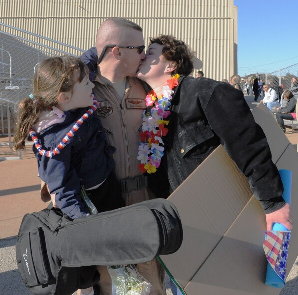 DYESS AIR FORCE BASE, Texas - Capt. Dan Corindia is welcomed home by his wife and daughter from deployment performing operations in support of Operations Enduring and Iraqi Freedom, here, 21 Feb.  More than 140 Airmen from the 317th Airlift Group returned from Southwest Asia. Capt. Corindia is a member of the 39th Airlift Squadron. (U.S. Air Force photo by Staff Sgt Connor Estes).  