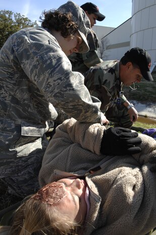 Staff Sgt. Jillian Marino and Capt. Luis Morales take care of a victim during an exercise on Charleston AFB Feb. 23. The base conducted the exercise to test how Airmen respond to a simulated explosion caused by an improvised explosive device. Sergeant Marino is a medical technician and Captain Morales is a flight nurse. Both are members of the 437th Medical Group. (U.S. Air Force photo/Senior Airman Katie Gieratz)