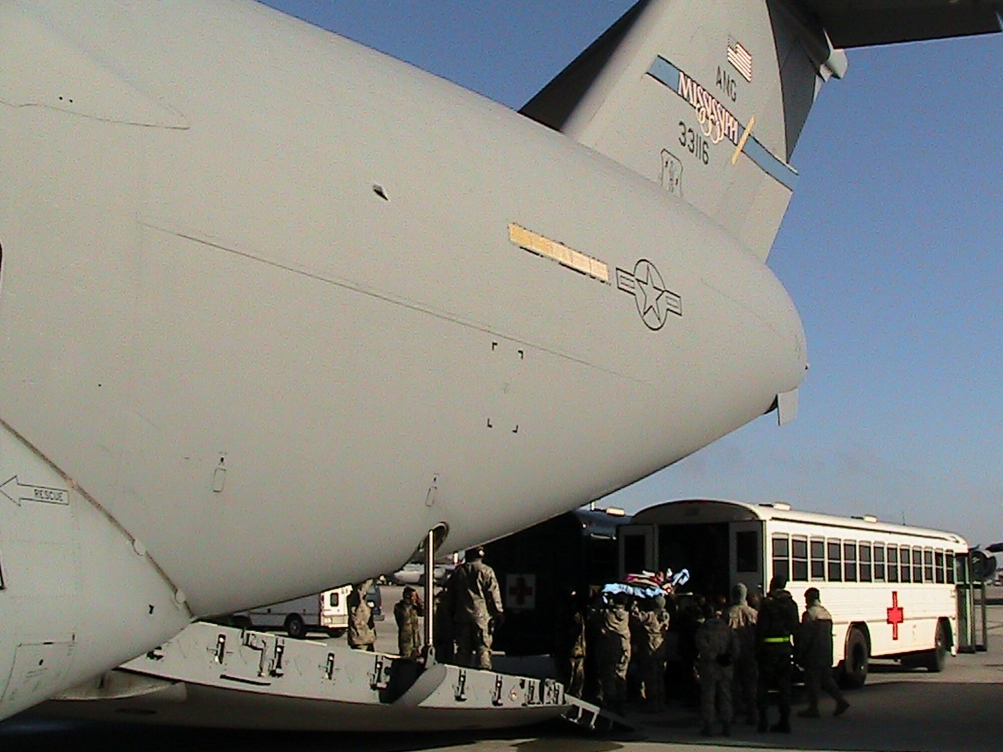 RAMSTEIN AIR BASE, Germany -- An aeromedical evacuation crew and military members at Ramstein Air Base load a patient on to a C-17 Globemaster III on its way back to the United States to take patients to their next level of care (U.S. Air Force photo/Capt. Jonathan Stock)