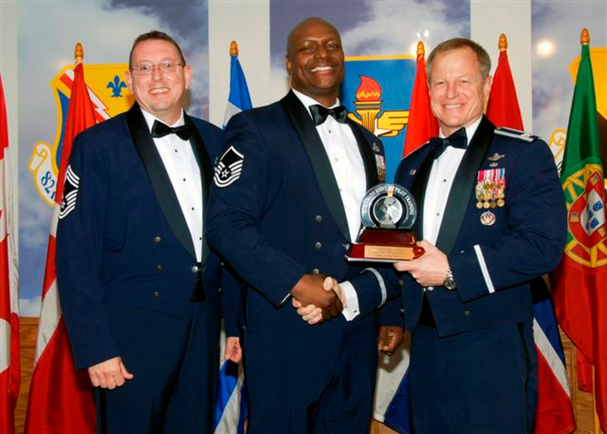 Master Sgt. Franklin Moore, center, accepts the award as the 80th Flying Training Wing's 2008 Senior NCO of the Year. The 80th FTW sergeant was recognized for role as the aircraft maintenance quality assurance office. He was recognized as the wing's Senior NCO of the Quater for the first and last quater of 2008. Also pictured is Col. David Petersen, 80th FTW commander, and Chief Master Sgt. Norman Thierolf, the wing's command chief. (U.S. Air Force photo) 