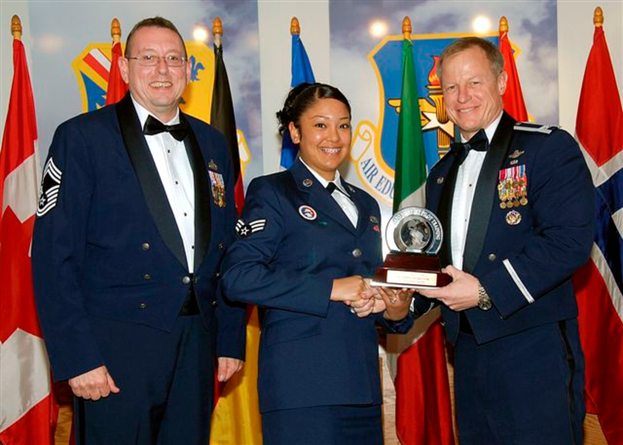 Senior Airman Stephanie Garcia, center, acceppts the award as the 80th Flying Training Wing's 2008 Airman of the Year. The 80th FTW Airman was recognized for experitise at managing the unit intro program which ensured that 134 inbound personnel were properly sponsored and welcomed to Sheppard. Also pictured is Col. David Petersen, 80th FTW commander, and Chief Master Sgt. Norman Thierolf, the wing's command chief. (U.S. Air Force photo) 